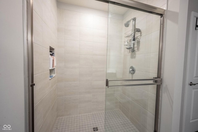 bathroom with a shower with door