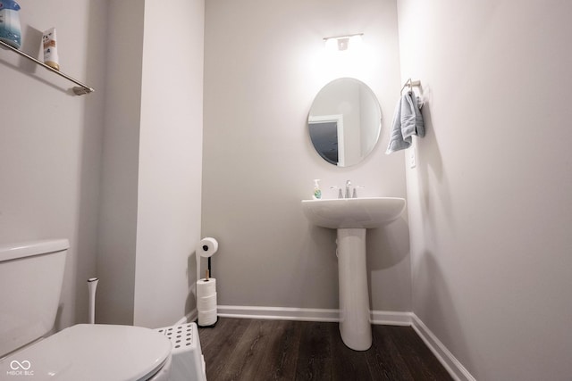 bathroom with hardwood / wood-style floors and toilet