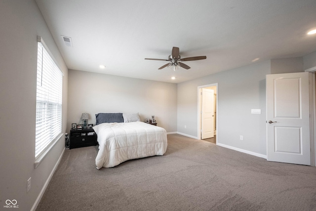 bedroom featuring ensuite bath, ceiling fan, and carpet floors