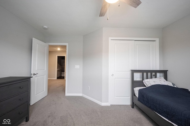 bedroom featuring a closet, light colored carpet, and ceiling fan