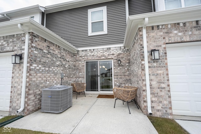 view of patio / terrace featuring central AC unit and a garage