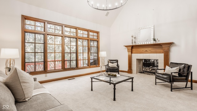 sitting room featuring visible vents, high vaulted ceiling, carpet, a fireplace, and baseboards