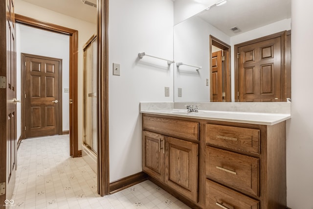 full bath featuring visible vents, baseboards, a stall shower, tile patterned floors, and vanity