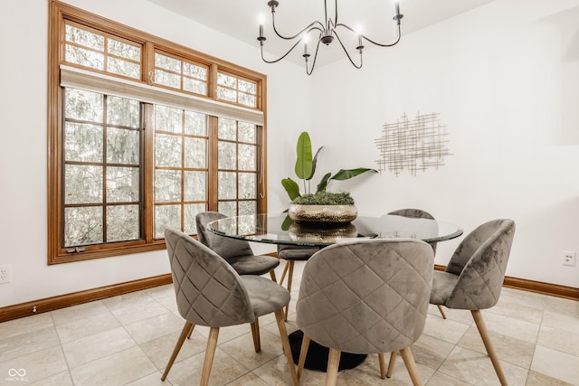 dining room with light tile patterned floors, baseboards, and a chandelier