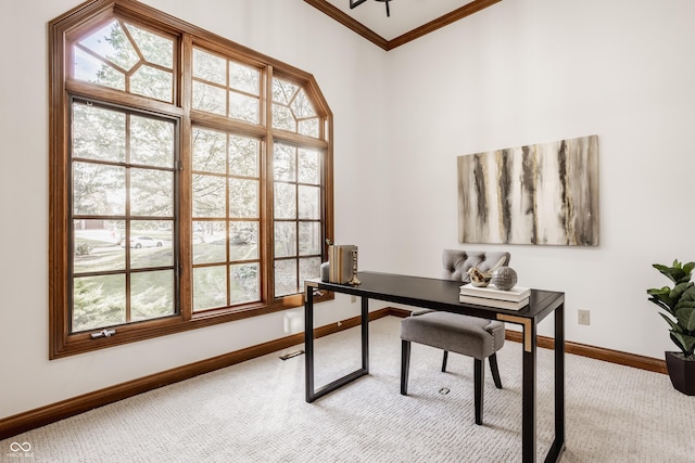 carpeted office with a wealth of natural light, baseboards, and crown molding