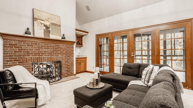 carpeted living room with french doors, baseboards, high vaulted ceiling, and a fireplace