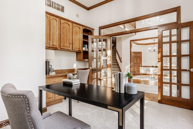 office space featuring crown molding, visible vents, and a chandelier