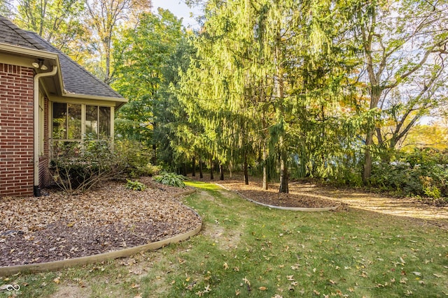 view of yard featuring a sunroom