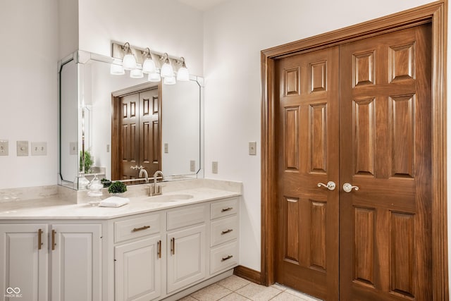 bathroom with tile patterned floors and vanity