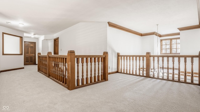 hallway featuring carpet flooring, baseboards, and ornamental molding