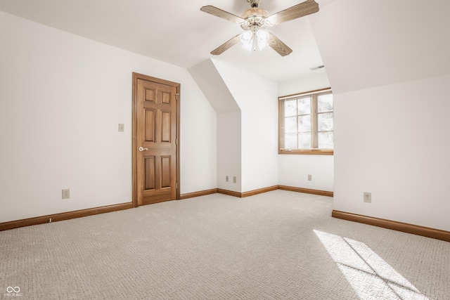 additional living space featuring visible vents, baseboards, ceiling fan, vaulted ceiling, and carpet flooring