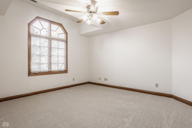 unfurnished room with visible vents, baseboards, a ceiling fan, and carpet flooring