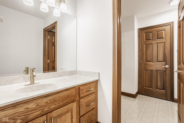 bathroom featuring vanity, tile patterned floors, and baseboards