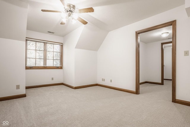 additional living space with a ceiling fan, baseboards, visible vents, carpet floors, and lofted ceiling