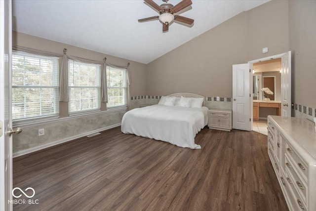 bedroom featuring ceiling fan, dark wood-type flooring, high vaulted ceiling, and ensuite bath