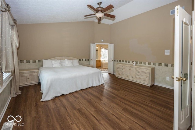 unfurnished bedroom with vaulted ceiling, dark hardwood / wood-style floors, a textured ceiling, and ceiling fan