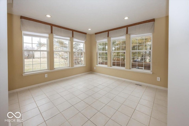 tiled spare room with a wealth of natural light