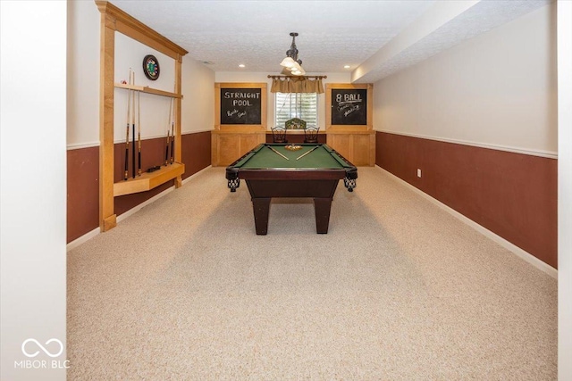 playroom featuring pool table, carpet, a textured ceiling, and wood walls