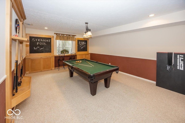 rec room featuring light colored carpet, billiards, and a textured ceiling