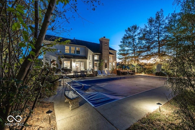 exterior space featuring a patio and a covered pool