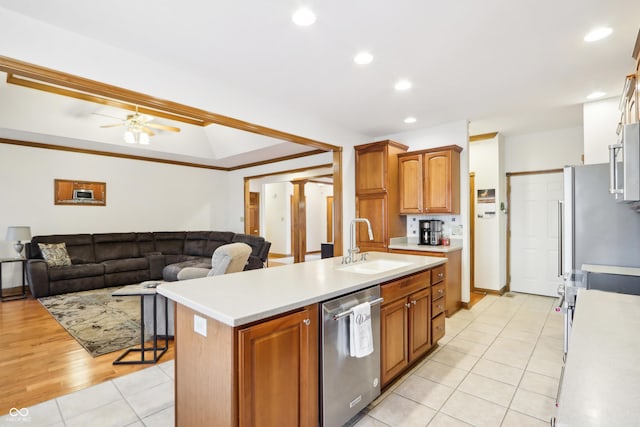 kitchen with ceiling fan, sink, light tile patterned floors, a center island with sink, and dishwasher