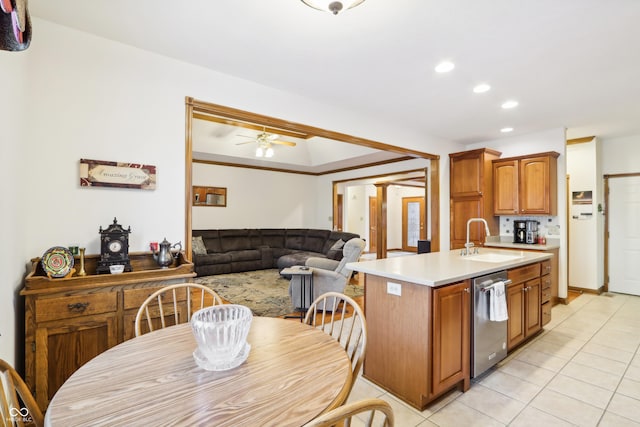 kitchen featuring ceiling fan, crown molding, sink, dishwasher, and light tile patterned flooring