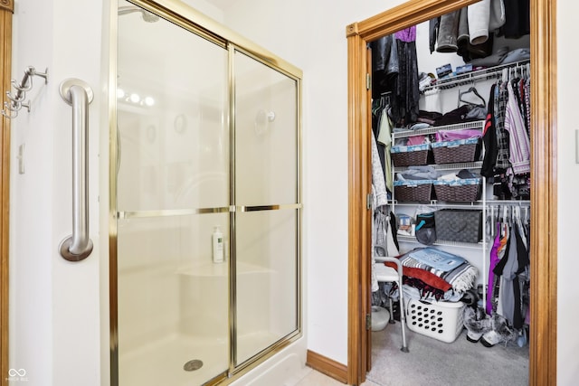 bathroom featuring a shower with door