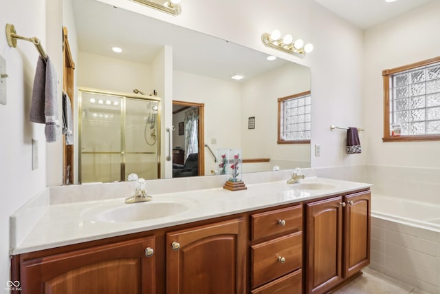 bathroom with vanity and shower with separate bathtub