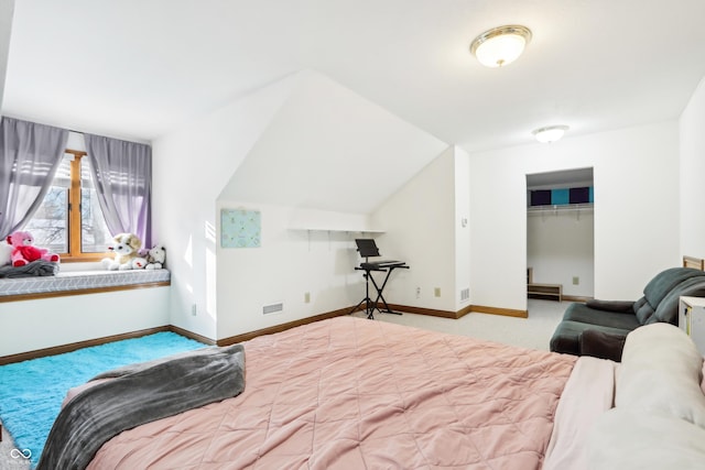 bedroom with light carpet and a closet