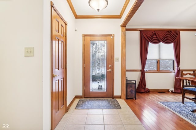 entrance foyer with light hardwood / wood-style floors and ornamental molding