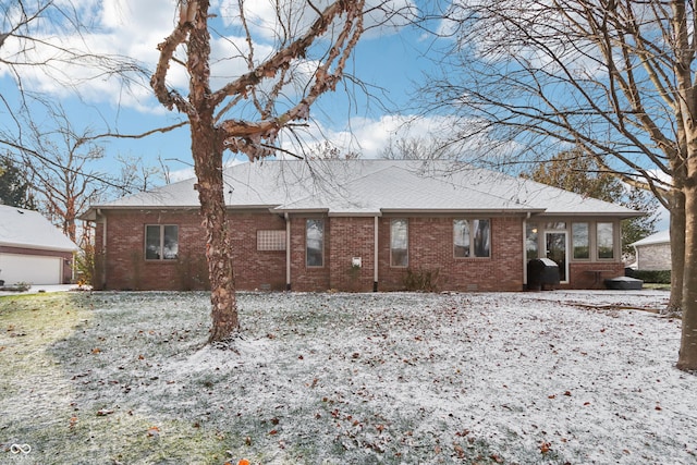 snow covered house with a garage