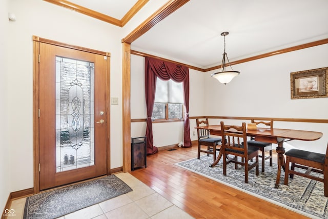 entryway with light hardwood / wood-style flooring and ornamental molding