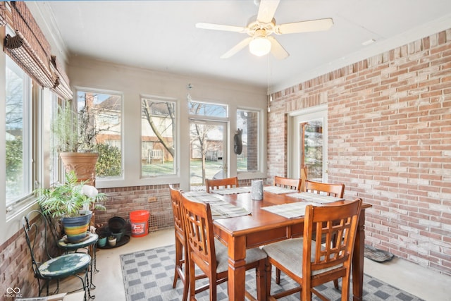 sunroom / solarium featuring ceiling fan