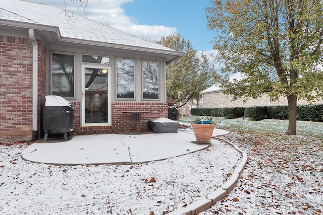 snow covered patio featuring area for grilling