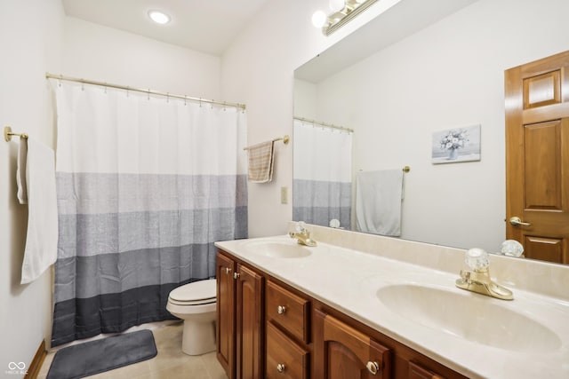 bathroom featuring tile patterned flooring, vanity, and toilet