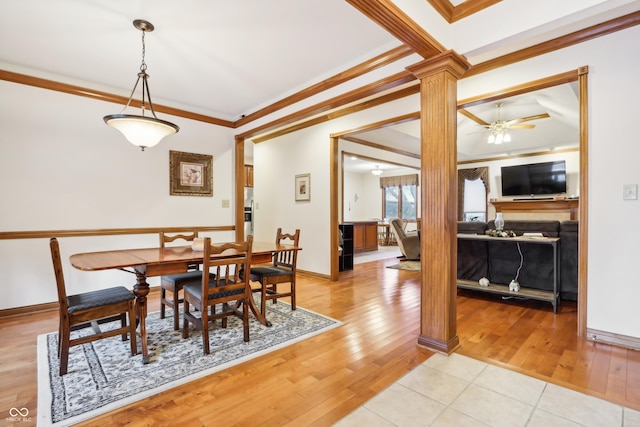 dining room featuring light wood-type flooring, ornate columns, ceiling fan, and crown molding