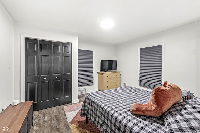 bedroom featuring hardwood / wood-style floors and a closet