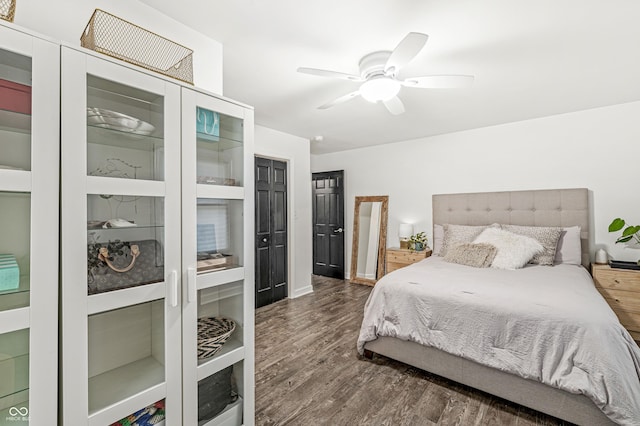 bedroom featuring ceiling fan and dark wood-type flooring