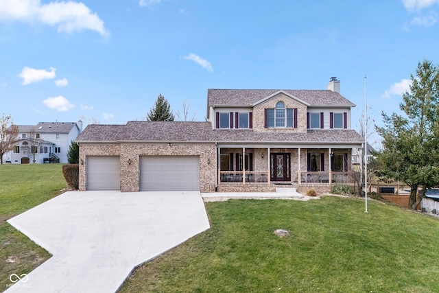 view of front of home with covered porch, a garage, and a front yard