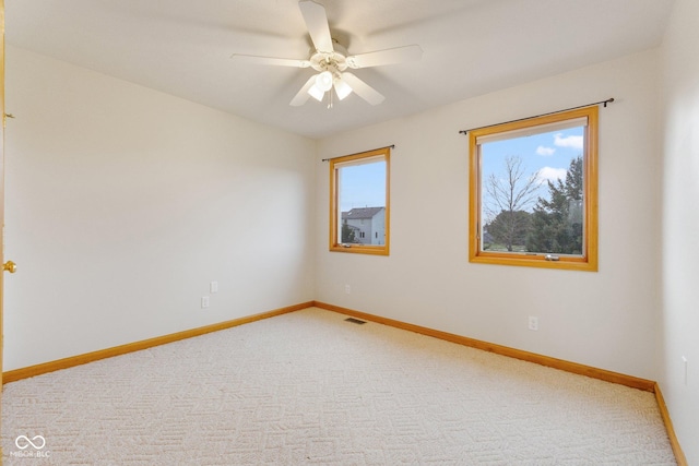 spare room with carpet and ceiling fan