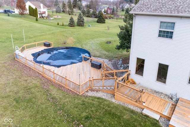 view of swimming pool with a yard and a wooden deck