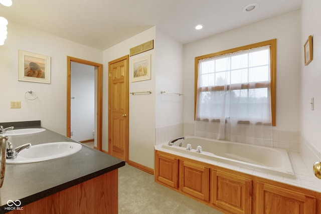 bathroom with vanity and a tub