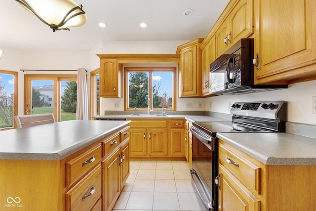 kitchen with sink, light tile patterned floors, stainless steel electric range, and a kitchen island