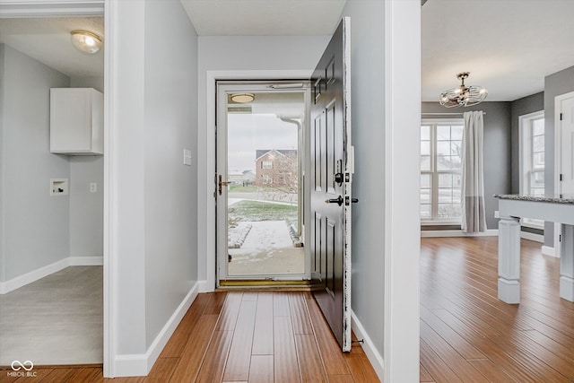 doorway to outside with light wood-type flooring