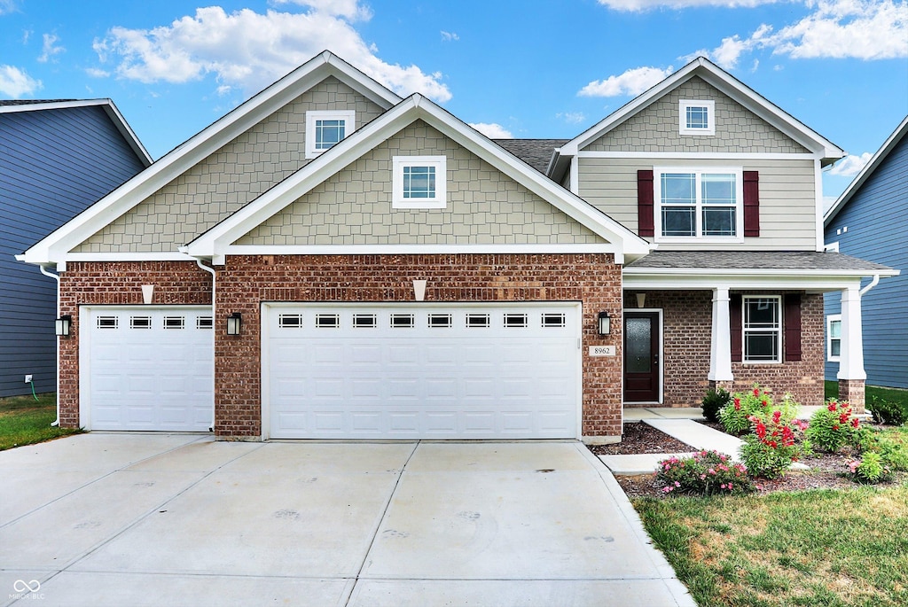 craftsman-style home with covered porch and a garage