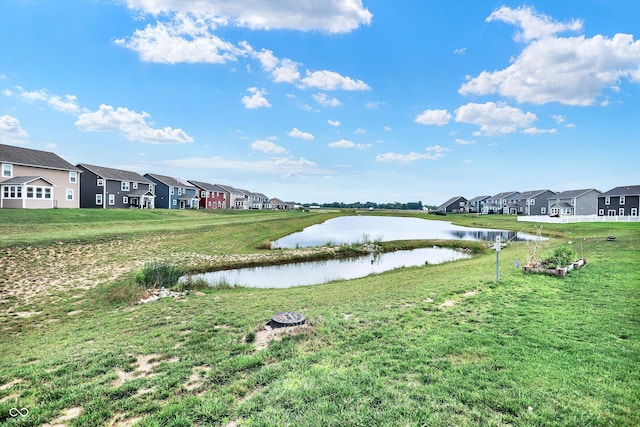 exterior space featuring a water view and a lawn