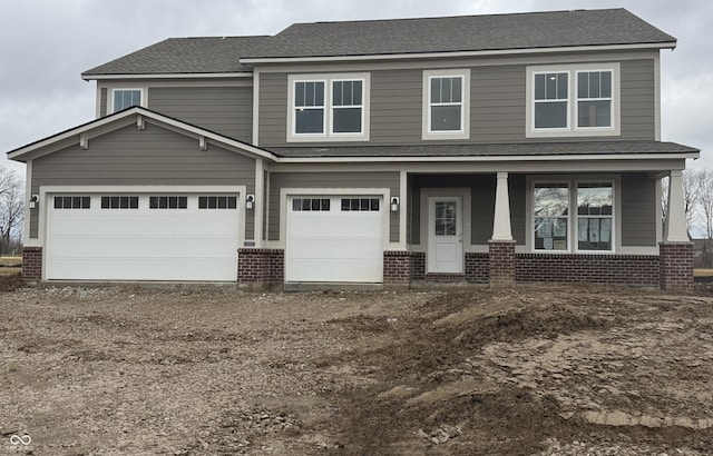 view of front facade with covered porch and a garage