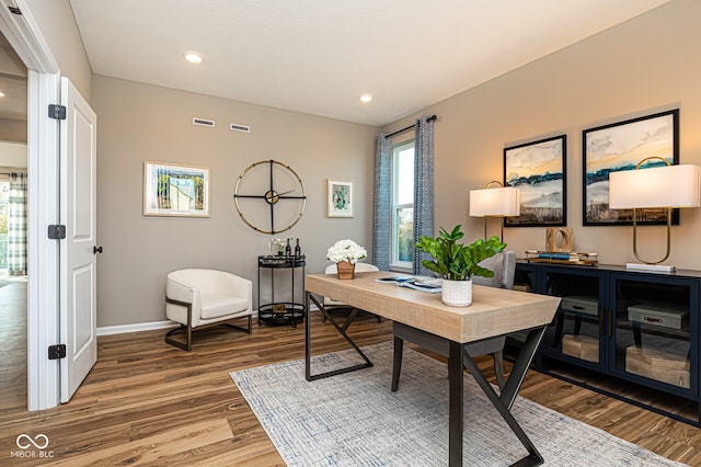 home office with wood-type flooring