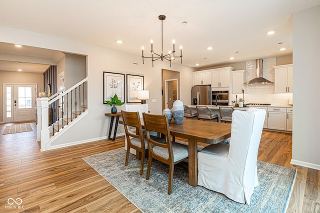 dining area with a chandelier and light hardwood / wood-style flooring