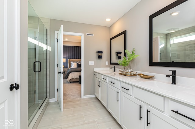 bathroom featuring vanity and an enclosed shower